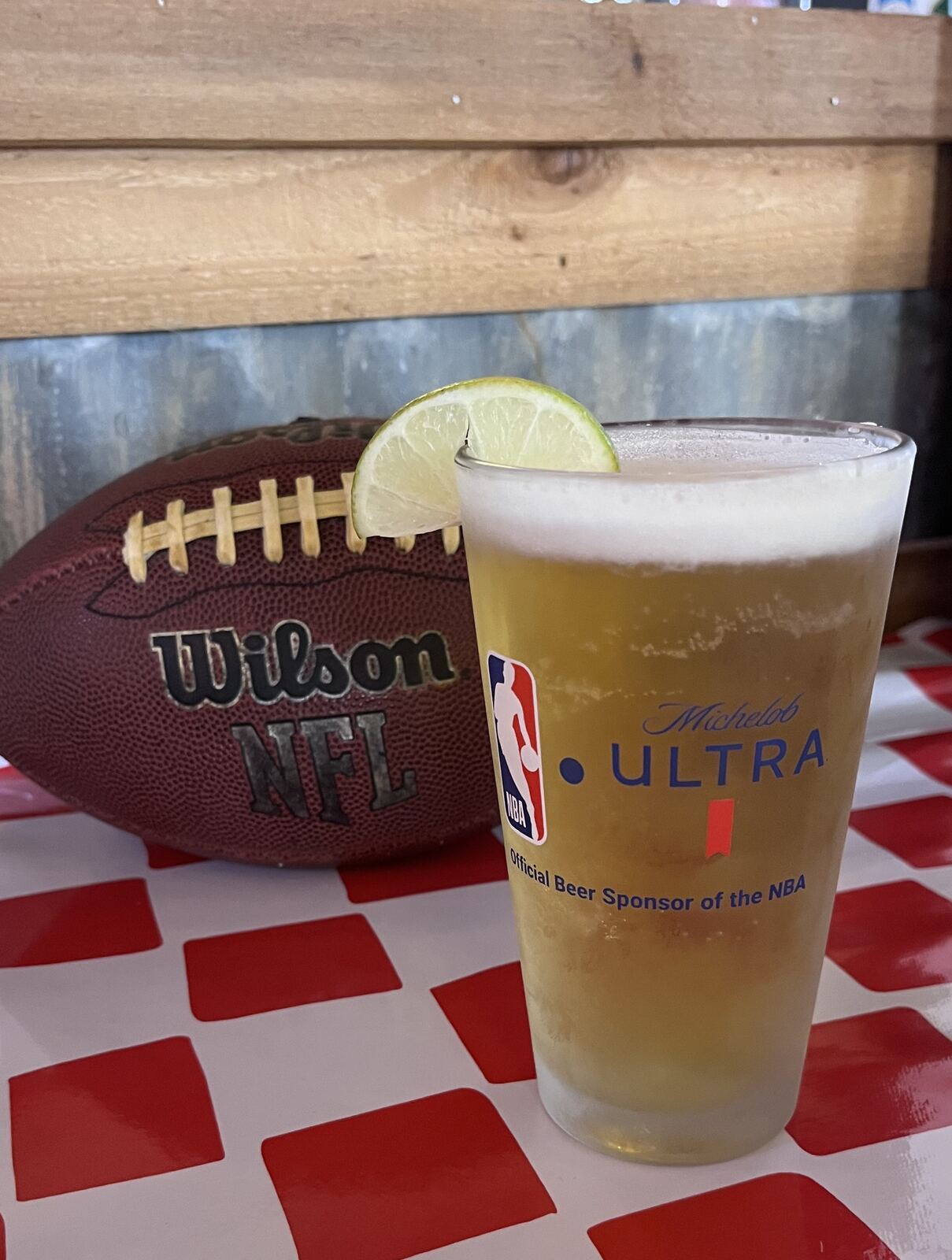 Michelob Ultra NBA pint glass with a lime wedge