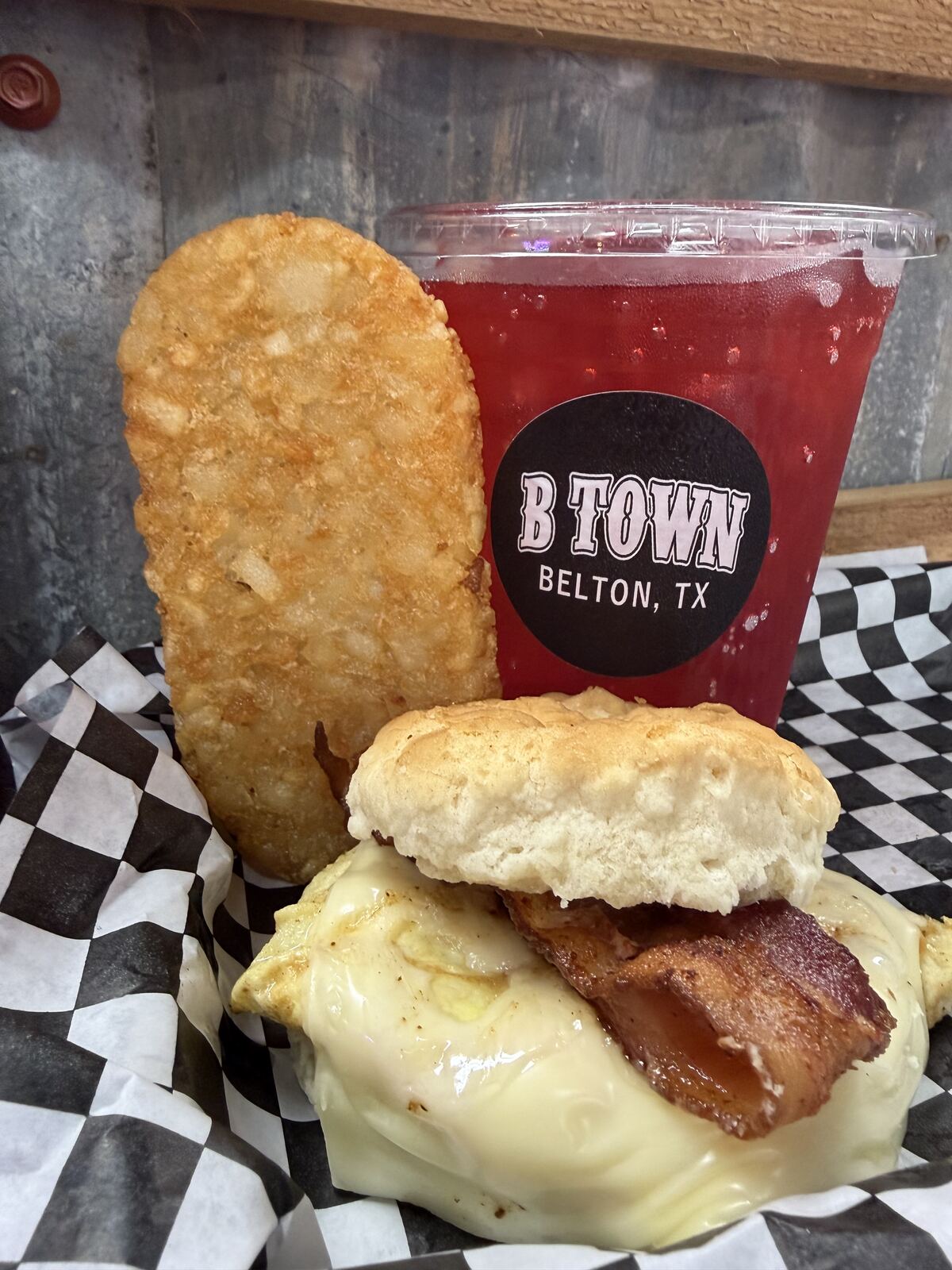 Bacon egg and cheese biscuit sandwich with hash brown
