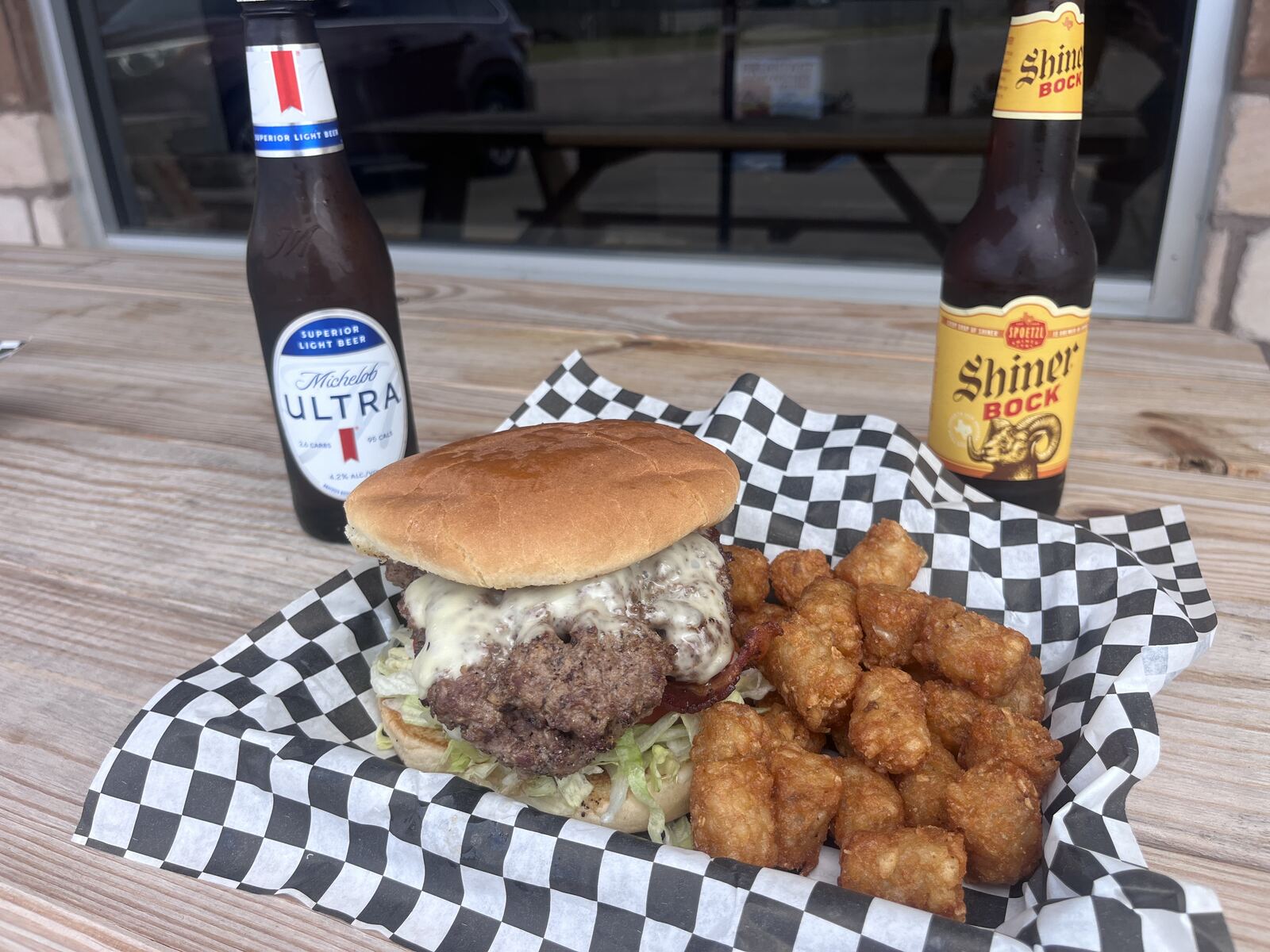 Bacon cheeseburger with tater tots, Michelob Ultra and Shiner Bock