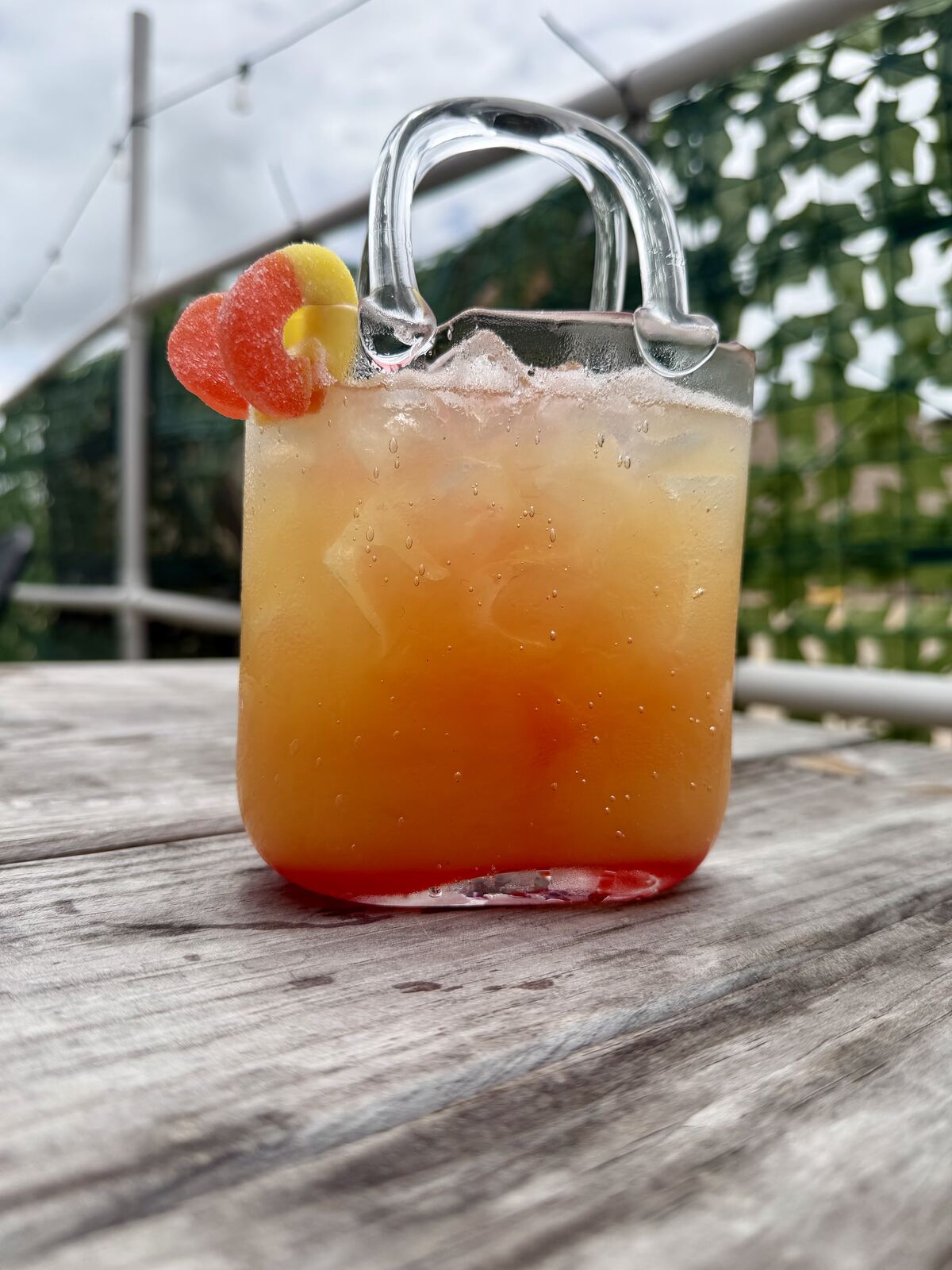 Orange cocktail with candy garnish